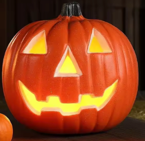 A glowing jack-o'-lantern pumpkin with a classic carved face, lit warmly from inside