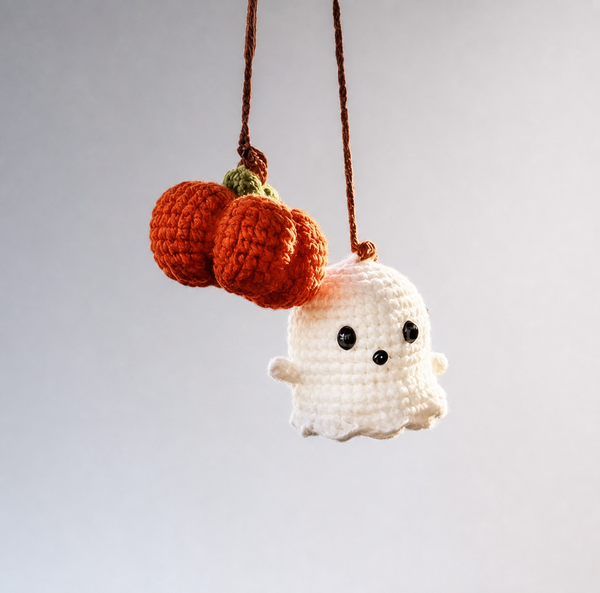 Crochet ghost charm with a pumpkin cluster on brown cords