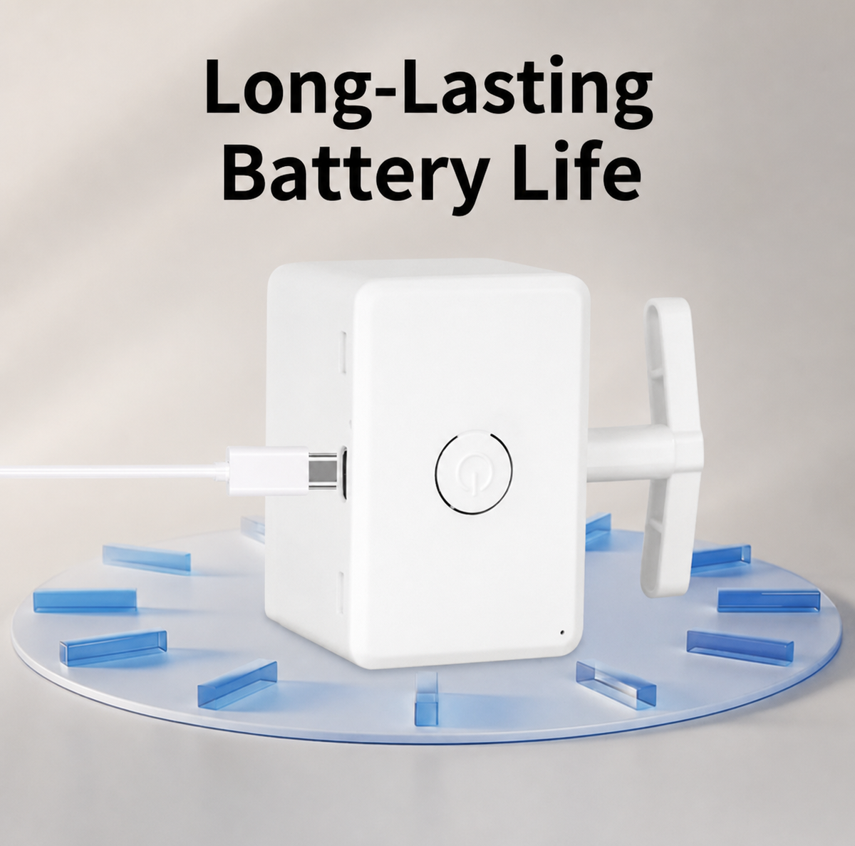 A white rectangular electronic device with a USB-C cable plugged into it, shown on a light gray background with the text 'Long-Lasting Battery Life' above it. The device sits on a translucent blue circular stand with small blue rectangular pieces around it.