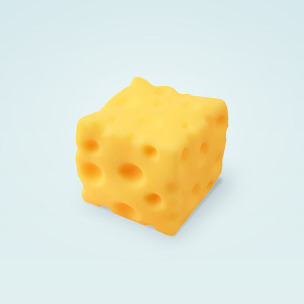 One yellow cheese squishy cube with round holes on a pale blue background
