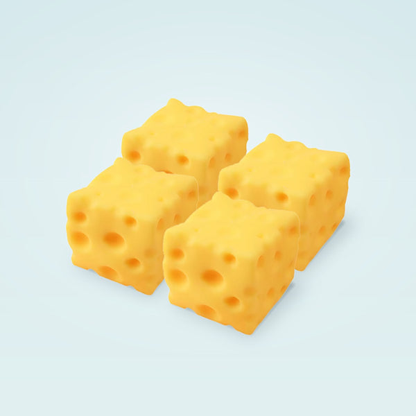 Four yellow cheese squishy cubes grouped together on a pale blue background