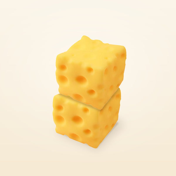 Two yellow cheese squishy cubes stacked one on top of the other on a cream background