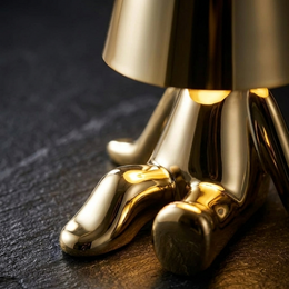 Perch gold lamp close-up on dark stone