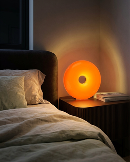 Anello ring lamp on a bedside table at night