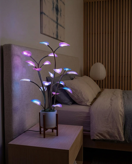 Flora plant lamp as a night light on a bedside table