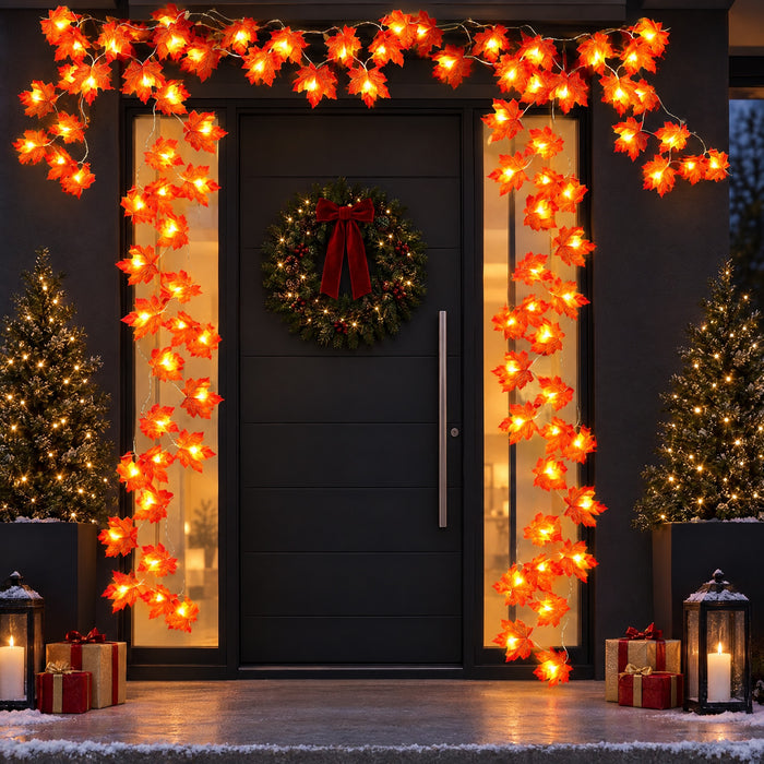 LED maple leaf garlands glowing around a modern front door decorated for Christmas. Several strands shown; wreath, trees, lanterns and gifts not included